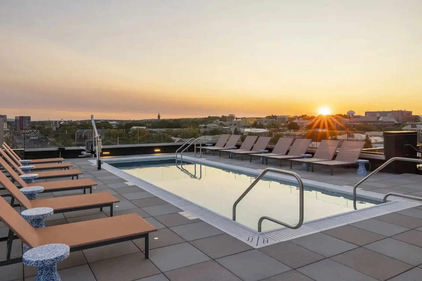 Pool surrounded by chairs at ōLiv Hetzel